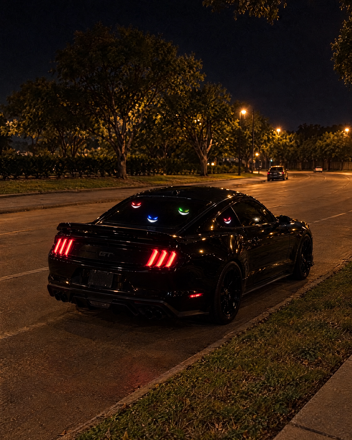 NightSmirk lights glowing on a black SUV rear window at night